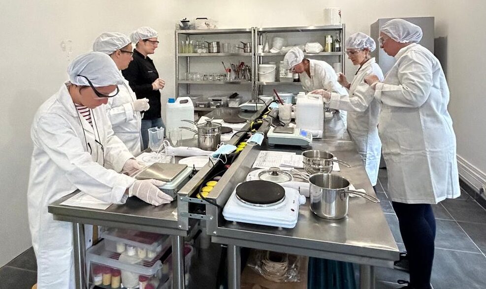 Stagiaires formulant cosmétiques biologiques et naturels en laboratoire lors de la formation shampoings solides